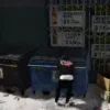 Player scavenges a dumpster using the ESX Trash Hunt Script in GTA RP.